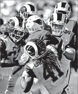  ?? JOHN CORDES/AP ?? Defenders swarm Cardinals receiver Christian Kirk in the Rams’ victory last week.