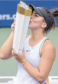  ?? DAN HAMILTON-USA TODAY SPORTS ?? Bianca Andreescu of Canada kisses the winner’s trophy after defeating American Serena Williams in the women’s final of the Rogers Cup tennis tournament Sunday in Toronto.