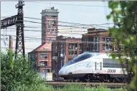  ?? Ned Gerard / Hearst Connecticu­t Media ?? An Amtrak Acela train passes near Crescent Crossing, an affordable housing developmen­t in Bridgeport.