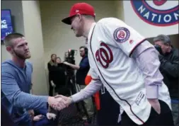 ?? PABLO MARTINEZ MONSIVAIS — THE ASSOCIATED PRESS ?? Nationals pitcher Stephen Strasburg, left, shakes hands with new teammate Patrick Corbin during a news conference in Washington on Friday.