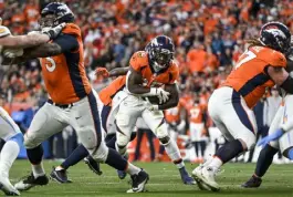  ?? Aaron Ontiveroz, The Denver Post ?? Denver’s Melvin Gordon runs through a hole cleared by Cameron Fleming (73) and Quinn Meinerz (77) against the Los Angeles Chargers on Sunday.