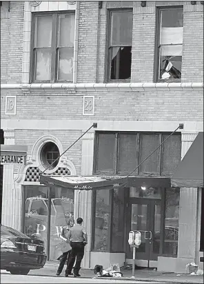  ?? Arkansas Democrat-Gazette/STATON BREIDENTHA­L ?? A Little Rock police team collects evidence Saturday outside the Power Ultra Lounge in the city’s downtown, where gunfire around 2:30 a.m. injured more than two dozen people. A witness said some people broke windows on the second floor of the venue to...