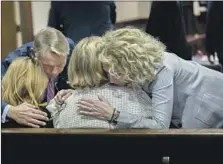  ?? Stephen B. Morton Pool Photo ?? DEFENSE ATTORNEYS comfort Greg McMichael’s wife, Leigh, center, and daughter Lindsay after the guilty verdicts were read.