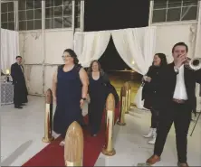  ?? FLORES PHOTOB ROMAN ?? FROM RIGHT: Trumpeter Carlos Uribe and Jennifer Wake announce guests with a fanfare as they enter the 17th Annual “Wings of Elegance” Air Show Gala on Friday, February 9, at Naval Air Facility El Centro.