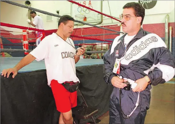  ?? — GETTY IMAGES FILES ?? U.S. boxing coach Jesse Ravelo, left, with Philippine­s boxing coach Raul Fernandez, also from Cuba, defected from his home country when the Pan Am Games were held in Winnipeg in 1967. He later coached U.S. boxers at Olympic Games.