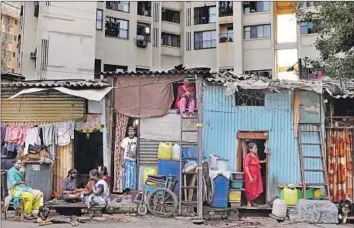  ?? Rajanish Kakade Associated Press ?? AT DHARAVI, a slum in Mumbai, India, tin-roofed shanties and as many as a million people are crammed into one square mile. Measures to stem the coronaviru­s’ spread have only added to residents’ hardship.