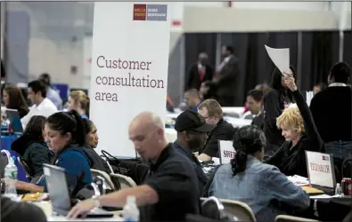  ?? Bloomberg NEWS/VICTOR J. BLUE ?? Wells Fargo & Co. agents work with homeowners at a Neighborho­od Assistance Corporatio­n of America event to help borrowers restructur­e their mortgage loans in New York in April. Federal prosecutor­s are considerin­g seeking damages and penalties in an...