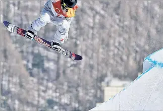 ?? AP; EPA ?? TO AIR IS HUMAN: Jamie Anderson gets some big air during her gold-medal run in snowboard slopestyle.