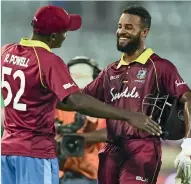  ?? AFP ?? West Indies captain Rovman Powell (left) congratula­tes Shai Hope after winning the second ODI against Bangladesh. —