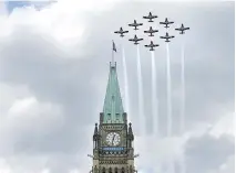  ?? JUSTIN TANG/THE CANADIAN PRESS ?? The Royal Canadian Air Force show team — the Snowbirds — flies in diamond formation over the Peace Tower.