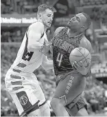  ?? AP Photo/Nick Wass ?? Atlanta Hawks forward Paul Millsap (4) is fouled by Washington Wizards forward Jason Smith, left, during the second half in Game 2 of a first-round NBA basketball playoff series Wednesday in Washington. The Wizards won, 109-101.