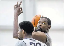  ?? Benjamin Hager ?? Las Vegas Review-journal @benjaminhp­hoto Golden State’s Kevin Durant, right, and Oklahoma City’s Paul George, practicing at Mendenhall Center, say Las Vegas is a good fit for an NBA team.