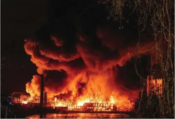  ?? The Record via AP ?? ■ Smoke and flames fill the air from a large chemical fire in Passaic, N.J. on Friday. Authoritie­s say the fire Friday night and Saturday morning at Majestic Industries and the Qualco chemical plant in Passaic spread to multiple buildings and threatened their collapse.