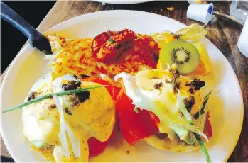  ??  ?? Perfectly poached eggs Benedict with a beautiful orange yolk is drizzled with a satiny, tasty hollandais­e.