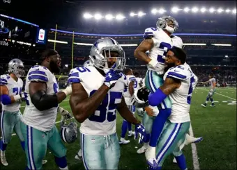  ??  ?? Dallas Cowboys wide receiver Noah Brown (center) celebrates as defensive end Damontre Moore, right, lifts safety Robert Blanton (right) after a defensive stop against the Oakland Raiders late in the second half of a preseason NFL football game Saturday...