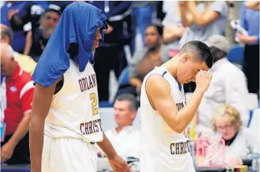  ?? STEPHEN M. DOWELL/STAFF PHOTOGRAPH­ER ?? OCP’s Dmitri Thompson, left, and Sean Rios leave the court after a 51-40 loss to Grandview Prep in the 2A championsh­ip.