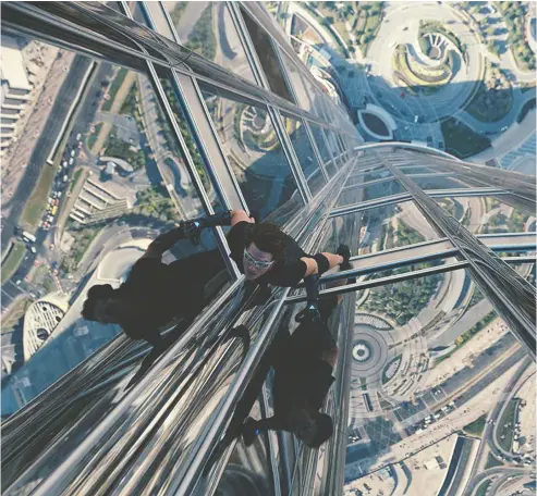  ?? PARAMOUNT PICTURES / SKYDANCE PRODUCTION­S ?? Hollywood superstar Tom Cruise is known for performing most of his own death-defying stunts in the Mission: Impossible movies,
including scaling the outside of Dubai's 163-storey Burj Khalifa in 2011's Mission: Impossible — Ghost Protocol.