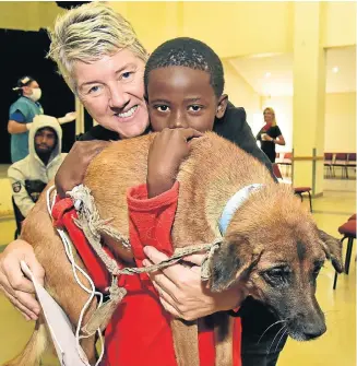  ?? Pictures: EUGENE COETZEE ?? HE’S NOT HEAVY: Vet Sue Bromley shows Leko Ngombini, 11, with his dog Bobby, where to go for the next slot in surgery