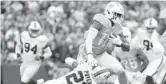  ?? TIMOTHY T LUDWIG/GETTY ?? Dolphins’ wide receiver DeVante Parker runs with the ball Sunday against the
Bills in Orchard Park, New York.