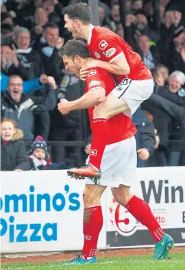  ??  ?? John Sutton celebrates after his opener in Ayr