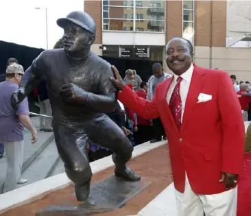  ?? Associated Press photos ?? In this Sept. 7, 2013, file photo, Hall of Fame second baseman Joe Morgan poses with his statue that was unveiled at Great American Ball Park in Cincinnati.