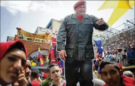  ?? ARIANA CUBILLOS / ASSOCIATED PRESS ?? A cutout of Venezuela’s late president, Hugo Chavez, stands out among supporters during a rally backing the new constituti­onal assembly outside the National Assembly building Monday in Caracas, Venezuela.