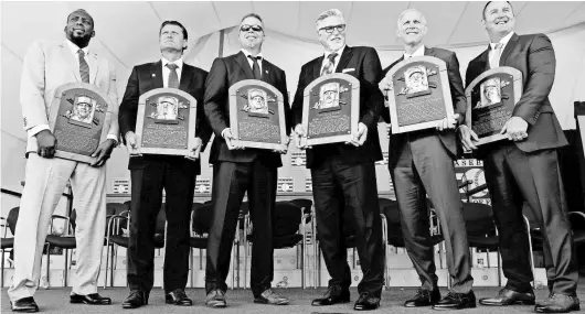  ?? ERIC SEALS/DETROIT FREE PRESS-USA TODAY NETWORK ?? The National Baseball Hall of Fame’s Class of 2018, with their hall plaques, from left: Vladimir Guerrero, Trevor Hoffman, Chipper Jones, Jack Morris, Alan Trammell and Jim Thome. The six were formally inducted July 29 in Cooperstow­n, New York.