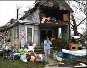  ?? TIMOTHY D. EASLEY — THE ASSOCIATED PRESS ?? Brittany Oakley calls relatives Friday outside of what is left of her home in Lakeview, Ohio.