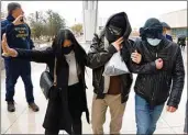  ?? BIZUAYEHU TESFAYE / LAS VEGAS REVIEW-JOURNAL ?? Alexander Smirnov, second from right, leaves the courthouse on Feb. 20 in Las Vegas.