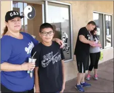  ?? WILLIAM ROLLER PHOTO ?? FROM LEFT: Julissa Rascon, Joshua Andres, Rascon’s son, Bryan Walker, owner of Shaolin Kung Fu Five Animals martial arts school, and a local student who volunteere­d to sweep El Centro downtown streets on Saturday.