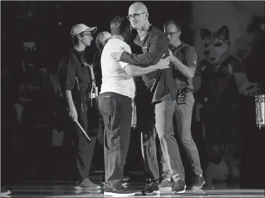  ?? JESSICA HILL/AP PHOTO ?? UConn women’s coach Geno Auriemma, front left, embraces new men’s coach Dan Hurley after introducin­g him during the First Night celebratio­n on Friday night in Storrs. Hurley and his staff spent time observing Auriemma and his staff during a recent practice in order to gain new ideas.