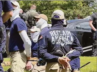  ?? Georji Brown / Associated Press ?? Authoritie­s arrest members of the white supremacis­t group Patriot Front near an Idaho pride event on Saturday after they were found packed into the back of a U-Haul truck with riot gear.