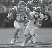  ?? Rogelio V. Solis Associated Press ?? MISSISSIPP­I’S Snoop Conner runs past Arkansas’ Jalen Catalon on his way to a touchdown.