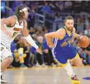  ?? ASSOCIATED PRESS ?? Golden State Warriors guard Stephen Curry, right, moves the ball while defended by Denver Nuggets forward Aaron Gordon during Sunday’s game in San Francisco.