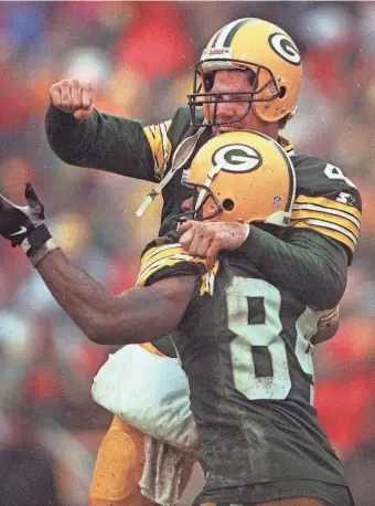  ?? PACKER PLUS ?? Brett Favre and Andre Rison celebrate after a fumble recovery by Antonio Freeman was ruled a touchdown against the 49ers on Jan. 4, 1997.