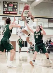  ?? TIM GODBEE / For the Calhoun Times ?? Calhoun’s Xaxton Goodson rises for a shot between Adairsvill­e’s Ethan Belcher (3) and Gaven Crunkelton.