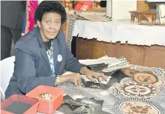  ?? Photo: Office of the Attorney-General ?? Fijian crafted recipient and masi maker Igatolo Toakase showcases her masi prints at the Fijian Pavillion at the Bonn Zone.