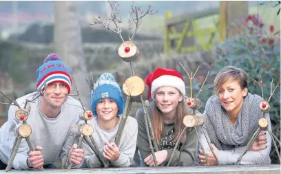  ?? Andy Lambert ?? The Unwin family – dad Dale, Harrison, 10, Olivia, 13, and mum Jilly – have been making and selling wooden reindeer to help the homeless