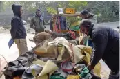  ?? — G.N. JHA ?? Mangled remains of an autoricksh­aw which was crushed under a container vehicle in an accident near IGI Stadium in New Delhi on Saturday.