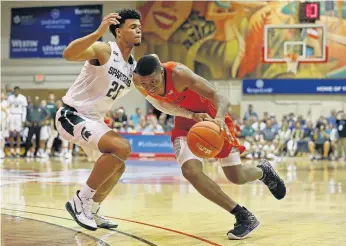  ?? MARCO GARCIA/ASSOCIATED PRESS FILE ?? Landers Nolley II, now in the NCAA transfer portal, tries to get around Michigan State forward Malik Hall during Virginia Tech’s 71-66 win against the third-ranked Spartans in a Maui Classic first-round game in Hawaii in November.