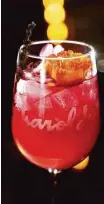  ??  ?? Summerthym­e Sangria is made with sangria, thyme, raspberry and mint-infused vodka with a splash of ginger ale, lemonlime soda, topped with an orange and edible flower.