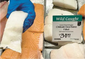  ?? JOSHUA GOODMAN/AP ?? Fillets of Chilean sea bass caught near the U.K.-controlled island of South Georgia are offered for sale last week at a Whole Foods Market in Cleveland, Ohio. The species is at the center of a diplomatic row between the U.S. and U.K.