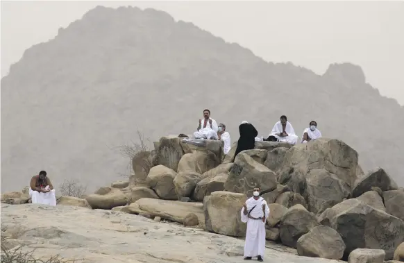  ?? AP ?? Pilgrims pray near Mount Arafat on the second day of Hajj. Coronaviru­s precaution­s mean only 60,000 people in Saudi Arabia are in attendance