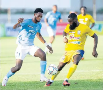  ?? RICARDO MAKYN ?? Waterhouse FC’s Jahvon James (left) takes on Molynes United defender Rushawn Plummer during their Jamaica Premier League game at the Anthony Spaulding Sports Complex in St Andrew yesterday.