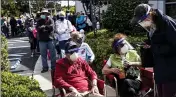  ?? ANDREW WEST — THE NEWS-PRESS ?? Joel and Susan Pittelman, from Naples, Fla., wait in line to receive COVID-19 vaccines on Tuesday at East County Regional Library in Lehigh Acres, Fla.