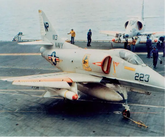  ?? (Photo courtesy of author.) ?? Above: BuNo. 151113 waits to be towed to the catapult for a mission in late March 1967. Two months later, on May 31, it was lost along with its pilot, Lt. Cmdr. Arvin R. Chauncey, who was captured and imprisoned by the North Vietnamese. It carries one Walleye under the starboard wing and an iron bomb under the port wing.