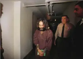  ?? THE ASSOCIATED PRESS ?? In this 1969file photo, Charles Manson is escorted to court in Los Angeles during an arraignmen­t phase. Authoritie­s say Manson, cult leader and mastermind behind 1969 deaths of actress Sharon Tate and several others, died on Sunday. He was 83.