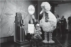  ?? Evan Agostini, Invision ?? Big Bird and puppeteer Caroll Spinney participat­e in the ceremonial lighting of the Empire State Building in honor of Sesame Street’s 50th anniversar­y in New York.