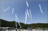  ?? ASSOCIATED PRESS FILE PHOTO ?? North Korean defectors release balloons carrying leaflets condemning North Korean leader Kim Jong Un and his government’s policies, in Paju, near the border with North Korea, South Korea, on Oct. 10, 2014.