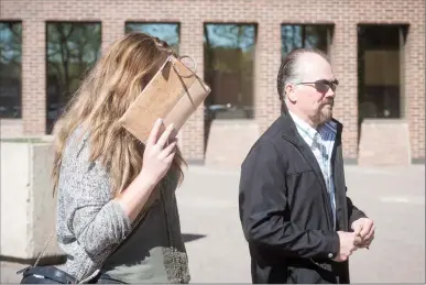  ?? Herald photo by Tijana Martin ?? Dean Friehaut, and a family member, leave the Lethbridge court house on Monday after revoking his surety for his wife Lisa Freihaut, who is accused of killing her mother early last year. @TMartinHer­ald